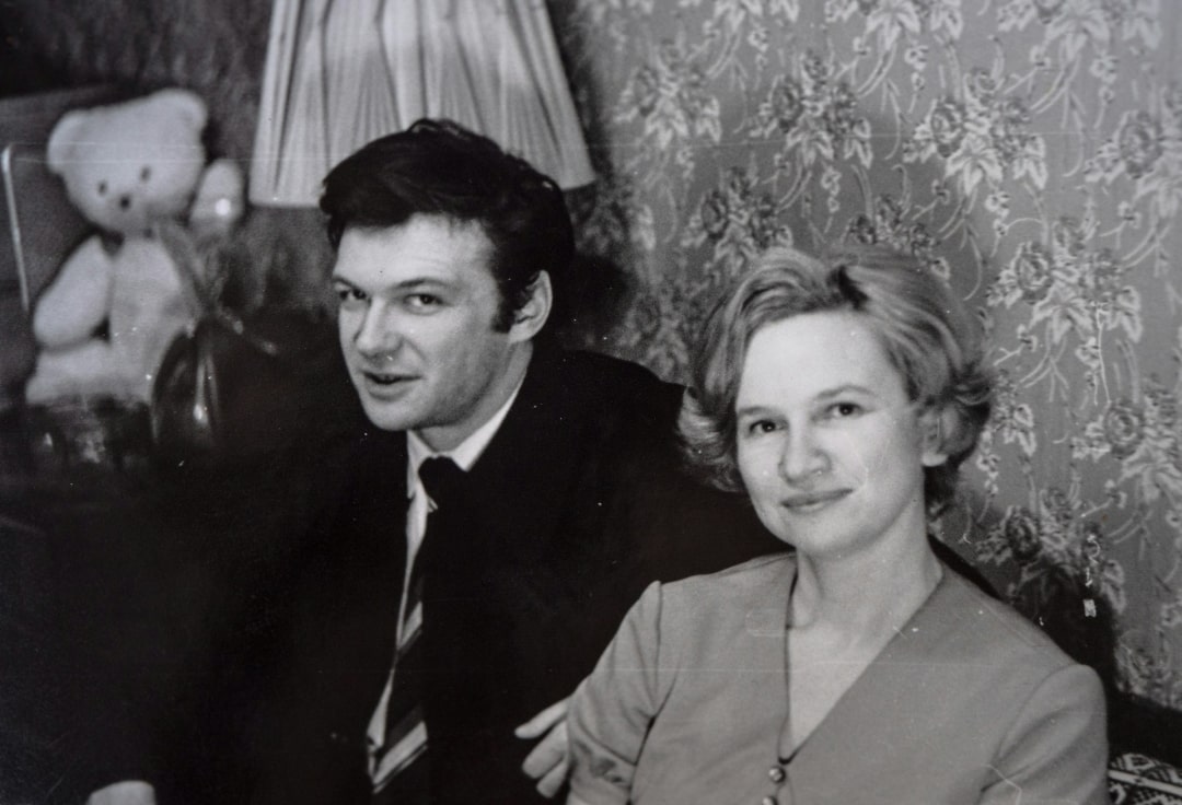 Couple sitting together indoors, illustrating familial bonds