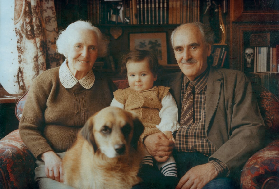 Grandparents with their grandchild, demonstrating generational genetic continuity