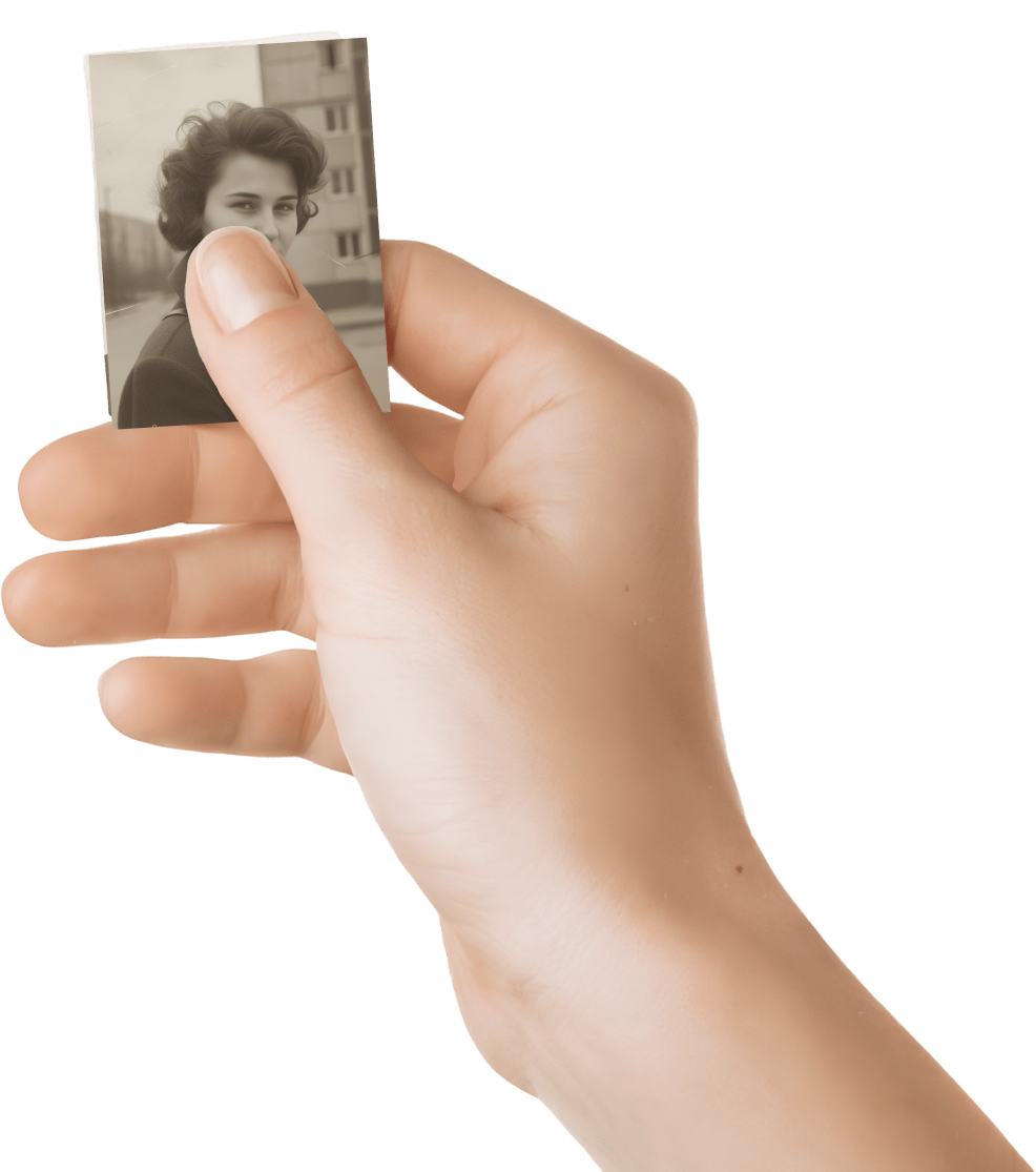 Hand holding old family photographs