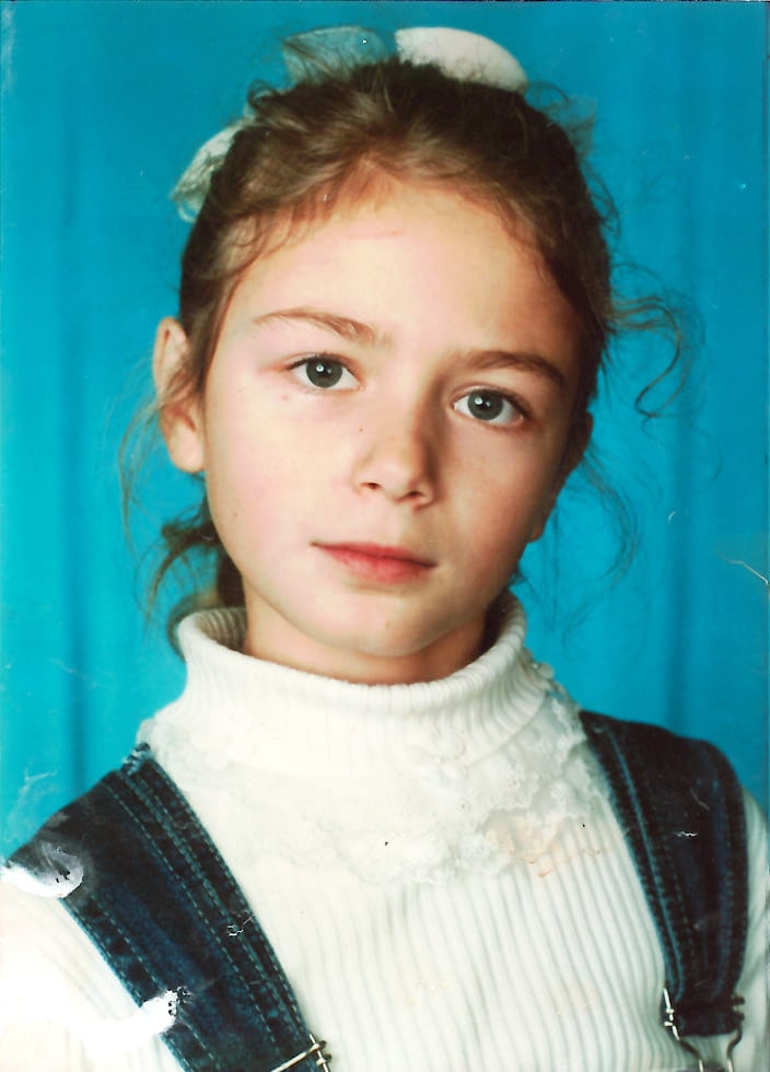 Little girl in a white sweater, representing familial traits
